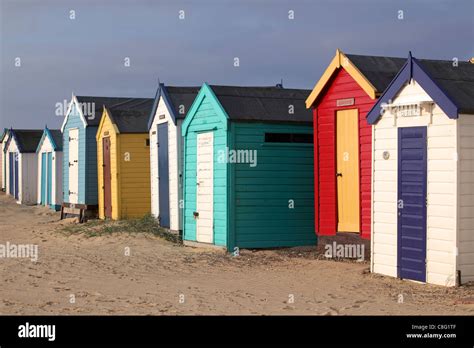 Colorful Row Of Wooden Beach Bathing Huts On Southwold Beach Strand