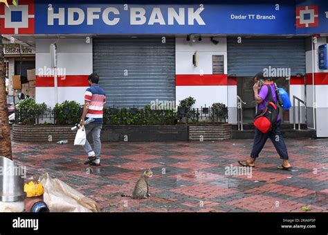 People Walk Past HDFC Bank Branch In Mumbai Housing Development