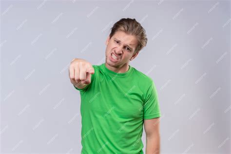 Free Photo Young Handsome Man Wearing Green T Shirt Pointing With