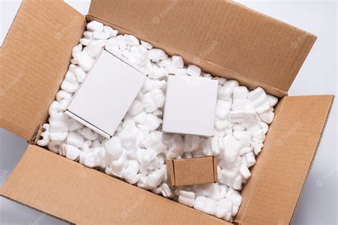 Premium Photo Lot Of Loose White Filler Shipping Packing Peanuts In Cardboard Box