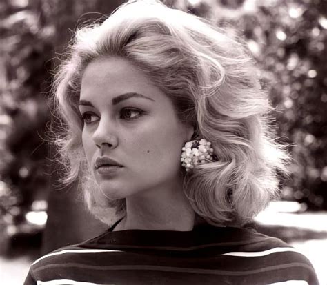 A Black And White Photo Of A Woman With Short Blonde Hair Wearing An