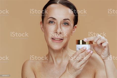 Portrait Of Happy Modern 40 Years Old Woman On Beige Background Stock