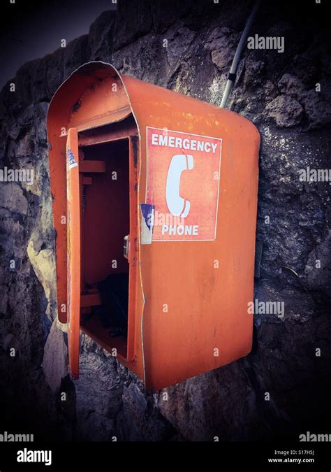 Orange Emergency Phone Box Attached To A Wall At The Coast Stock Photo