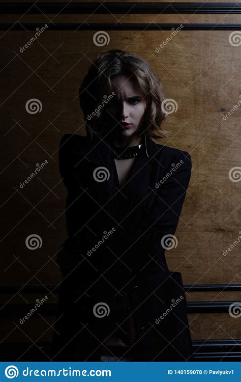 Angry Brunette Model With Curly Hair Posing With Contrast Light Stock Photo Image Of Shadows