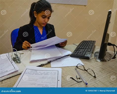 An Indian Human Resource Department Girl Verifying Resume Of Candidates