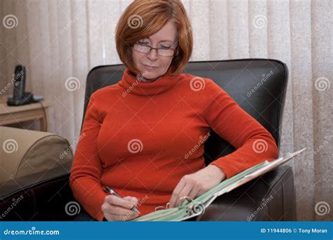 Redheaded Woman In Her Best Years With Very Curly Hair Under A Weeping