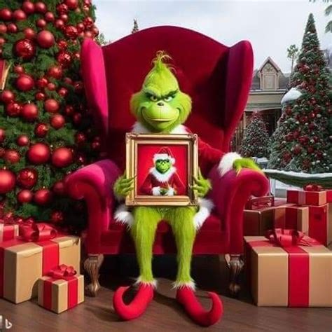 The Grinch Sitting In A Red Chair Holding A Framed Photo With Presents