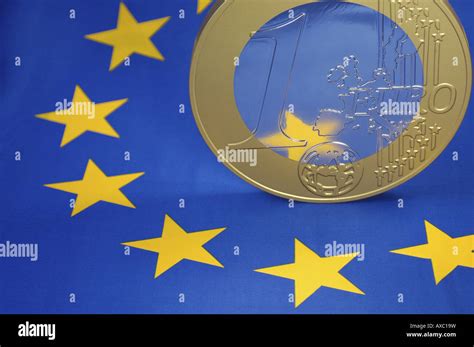 Euro coin on European flag Stock Photo - Alamy