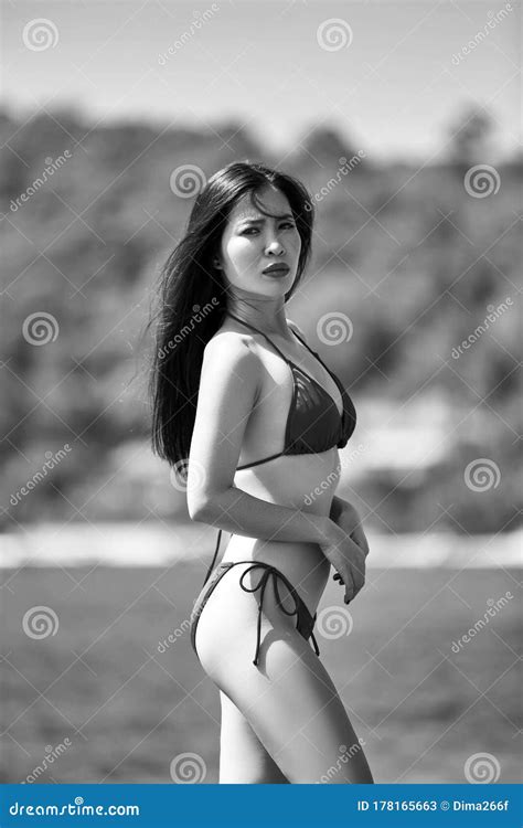 Beautiful Asian Girl In A Blue Bikini Posing On A Beach Grayscale Image Stock Image Image Of