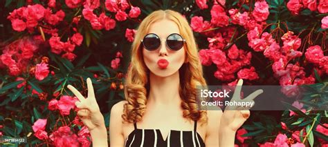 Portrait Of Beautiful Woman Blowing Her Lips With Red Lipstick Sending