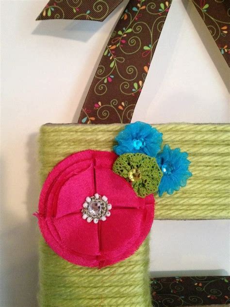 Yarn Wrapped Letter Decorated With Coordinating Ribbon And Flowers