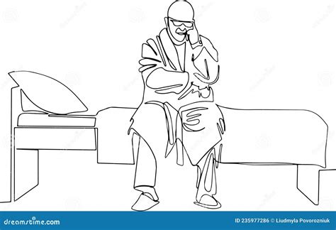 Pensive And Sad Mature Man In Pajamas And A Robe Sitting On A Bed Stock