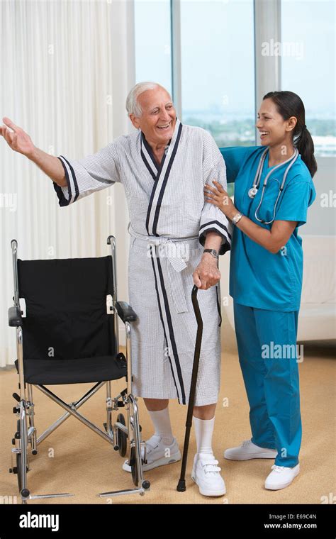 Nurse helping Senior patient use cane Stock Photo - Alamy