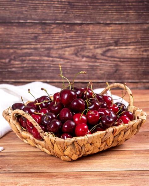 Premium Photo Fresh Cherry Ripe Cherries In A Basket On Wood