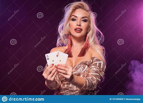 Blonde Woman With A Perfect Hairstyle And Bright Make Up Is Posing With Playing Cards In Her