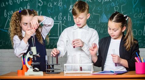 Childrens Day. Students Doing Biology Experiments with Microscope Stock ...