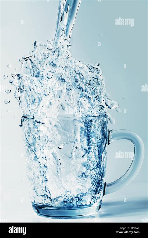 Pouring Water Into A Glass Mug Stock Photo Alamy