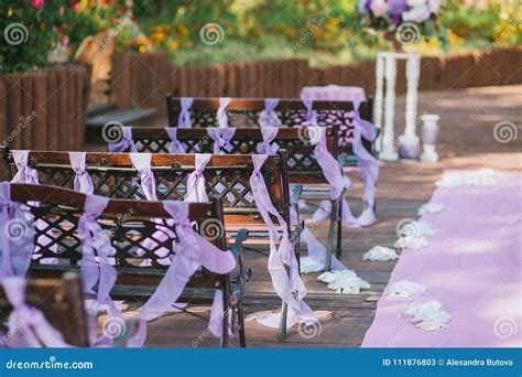Wooden Benches In The Wedding Ceremony Area In The Garden Decorated