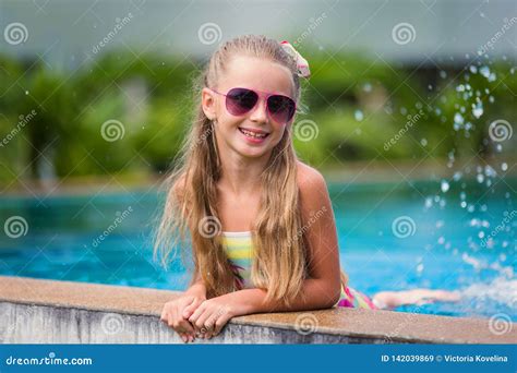 Cute Cheerful Smiling Girl In Sunglasses In The Pool On Holiday Summer