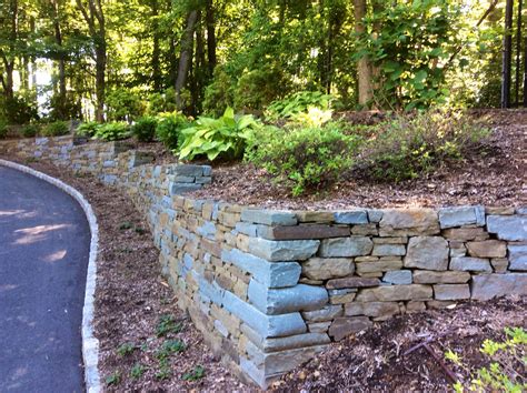 Dry Stack Snapped Blue Stone And Kearney Stone Retaining Walls Along Drive Way Hardscape