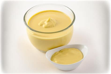 Premium Photo Yellow Sauce In A Little Glass Bowl Isolated On A White