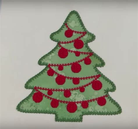 A Green Christmas Tree With Red Balls On It