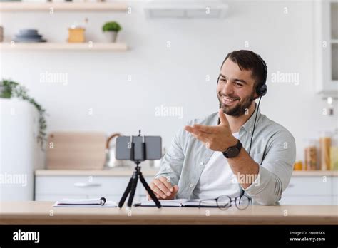 Happy Mature Caucasian Man Student With Beard In Headphones Chatting