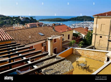 View Over Roofs And Rooftop Patio Of Buildings Down To Harbour In Old