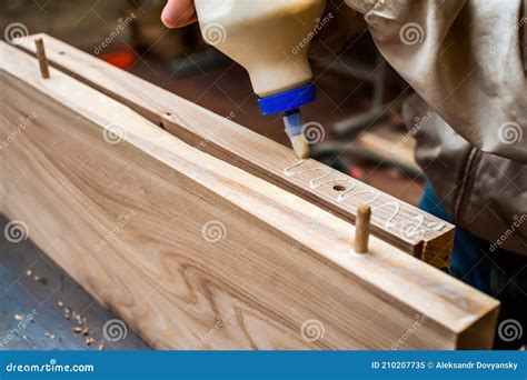 Gluing Boards in a Carpentry Workshop. Connecting with Dowels and Glue ...