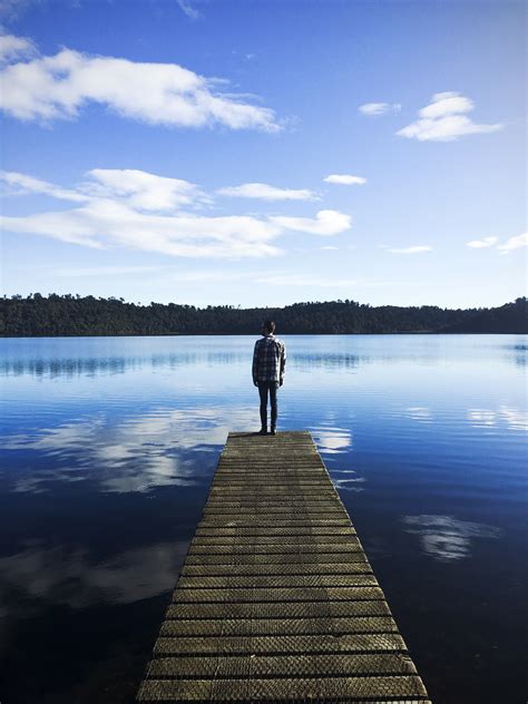 Man Standing On The Dock Looking At The Lake Landscape Image Free