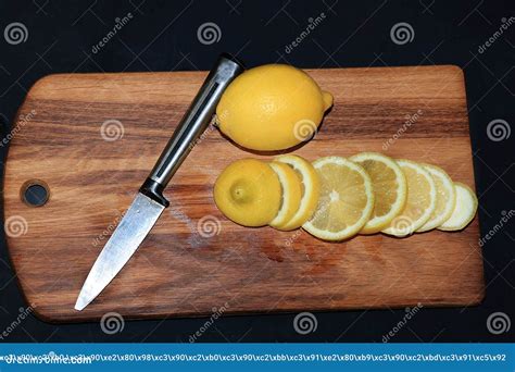 Slicing A Lemon On A Wooden Board Stock Photo Image Of Ripe Nature