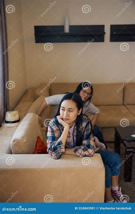 Upset Daughter Ignoring Her Irritated Mother After Home Conflict Stock