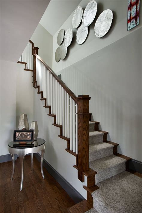 There Are Plates On The Wall Next To The Stairs In This House With Wood