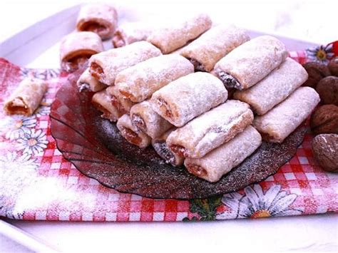 There Are Many Pastries Stacked On A Glass Platter With Red And White