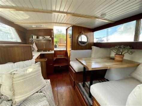 Boat Interior Design with Wood Flooring and White Pillows