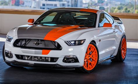 A White Mustang With Orange Stripes Parked In A Parking Lot