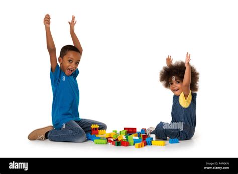 Two Little Cute African American Children Playing On The Floor With