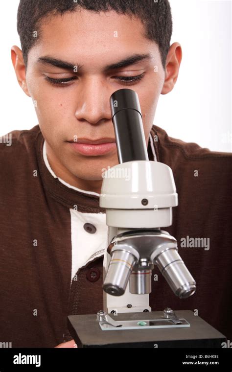 A Teenage Student Using A Microscope Stock Photo Alamy