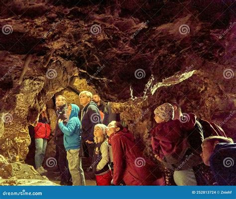 Tourists Marvel At The Geological Formations In A Cave In The Czech