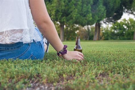 Premium Photo Low Section Of Woman Holding Beer Bottle While Relaxing