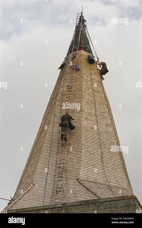 Workmen Replacing Shingle Tiles On Church Spire At Alfriston In East