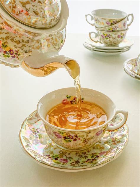 Teapot Pouring Tea Into Antique Flowered Cup Stock Photo Image Of