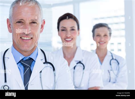 Portrait Of Three Smiling Medical Colleagues Looking At Camera Stock