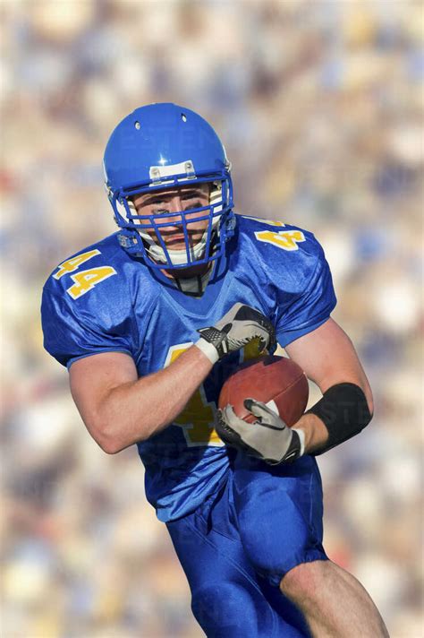 American Footballer Running With Ball Stock Photo