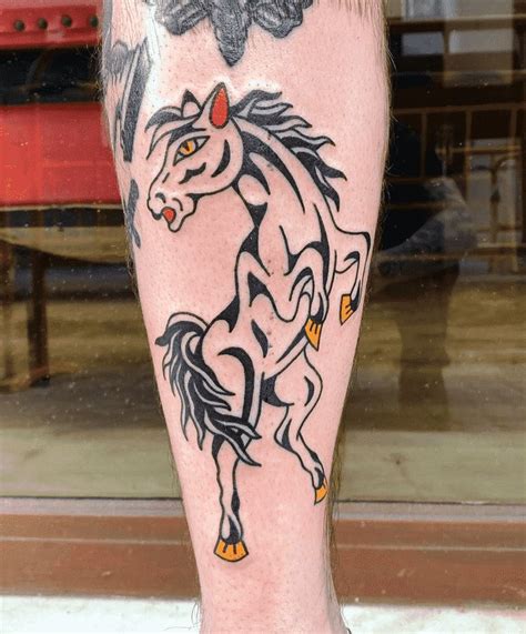 a man with a horse tattoo on his leg