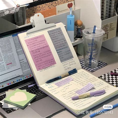 An Open Laptop Computer Sitting On Top Of A Desk Next To A Cup And Pen