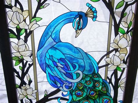 A Stained Glass Window With A Blue Peacock On It S Back And White