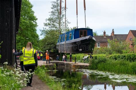 Barrowboat Being Lowered Into A Canal By A Crane In The Shropshire Town Of Newport Editorial