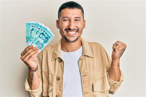 Handsome Man With Tattoos Holding 50 Yuan Chinese Banknotes Screaming