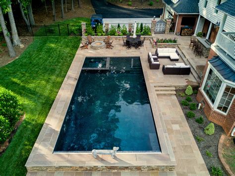 Geometric Pool Featuring A Flushed Spa And Tanning Ledge